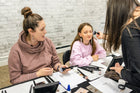 In-person makeup lesson with MisMacK Clean Cosmetics, showing a professional applying makeup on a client for a full beauty look.
